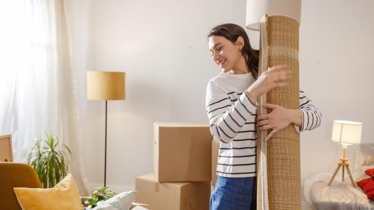 Young woman packing up apartment