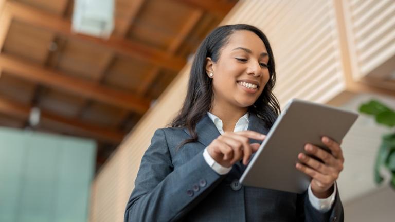 Businesswoman looks at tablet