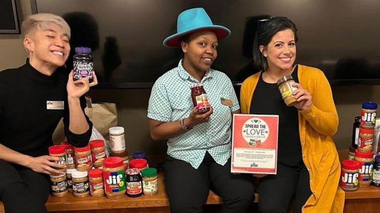 Onsite staff show peanut butter jars collected in food drive with Move for Hunger