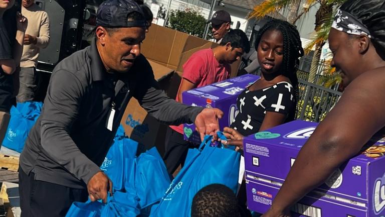 Hatching Hope volunteer distributes supplies to disaster victims.