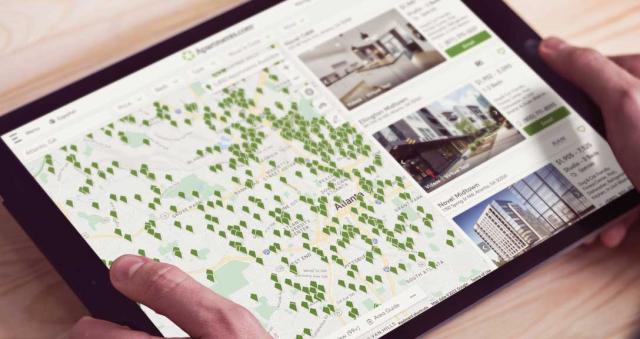 person holding tablet with Apartments.com