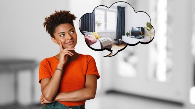 Woman stands in room imagining new apartment