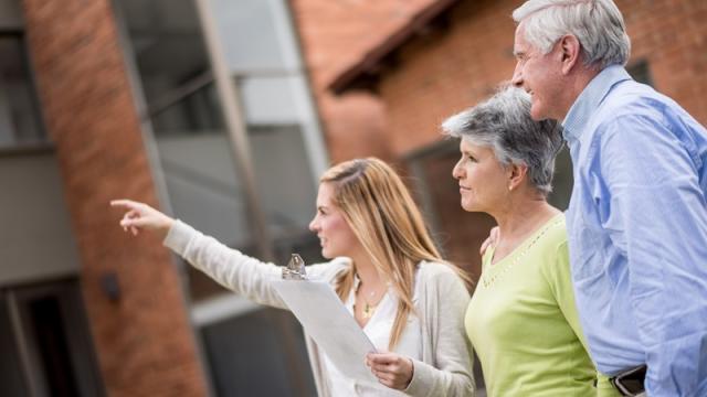 Leasing agent takes older renter couple on tour of building 