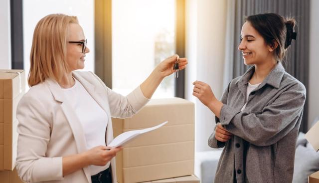 Landlord hands keys to their selected rental applicant. 