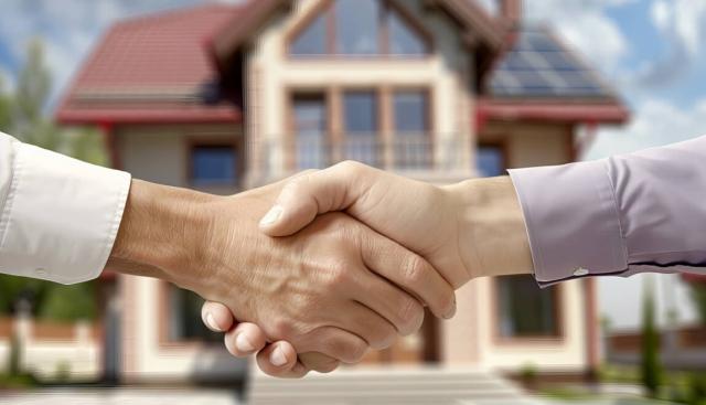 Landlord and renter shaking hands over rent negotiations. 