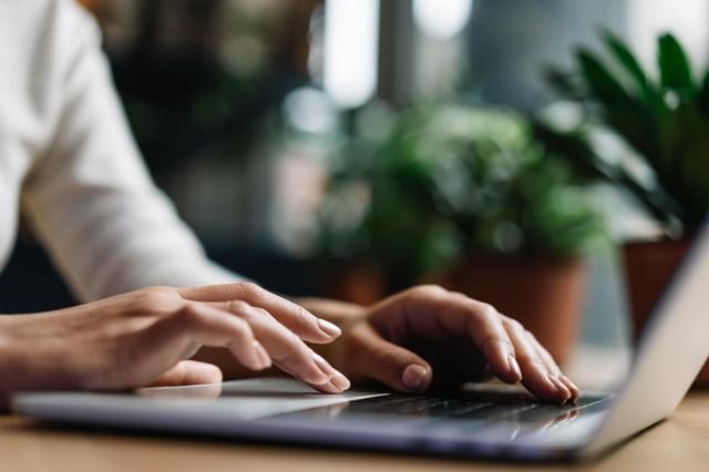 An image of a person typing on a laptop. 