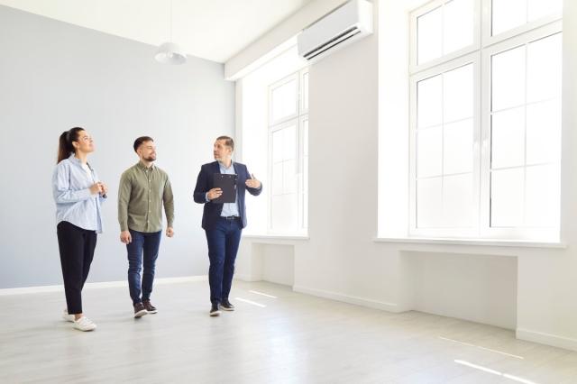 An image of a leasing agent showing renters a rental home.