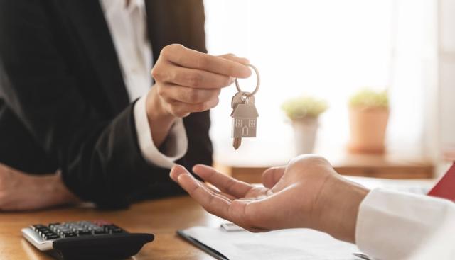 Landlord handing tenant home keys.