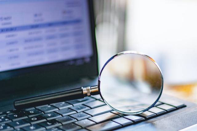 Magnifying glass sitting on a computer