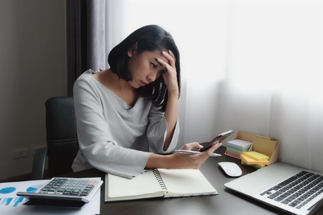 Woman holding mobile device