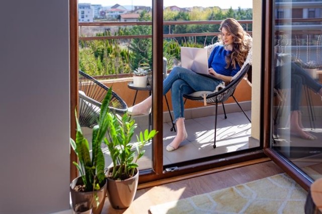 woman using laptop on a patio