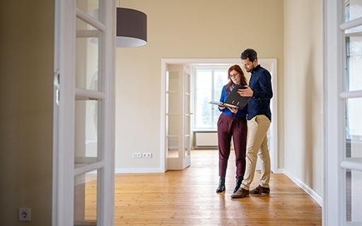 Two people in the living space of an empty rental