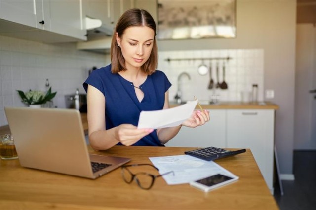 A woman looking over utility bills