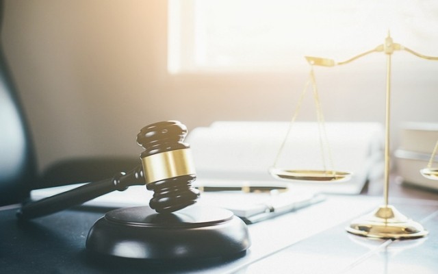 A courtroom scene with a gavel and desk