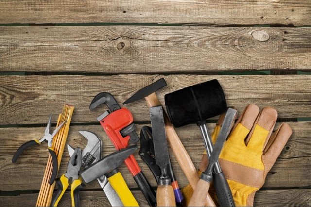 A tool kit including pliers, a wrench, and gloves