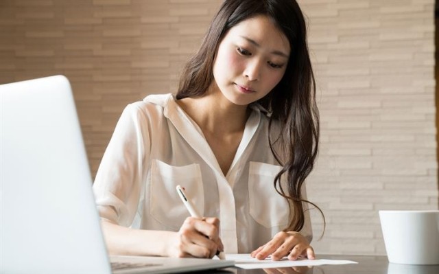 a landlord editing the content of a printed lease agreement draft with a pen