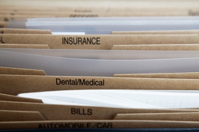 A selection of manilla folders labeled with different types of insurance