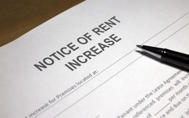 A pen atop a paper titled "Notice of rent increase"