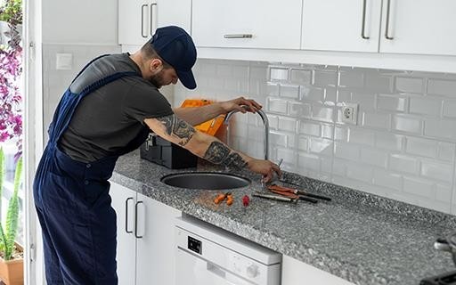 Maintenance man fixing a sink