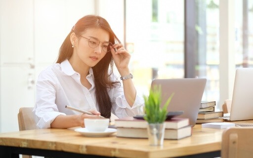 Lady sitting in front of computer.