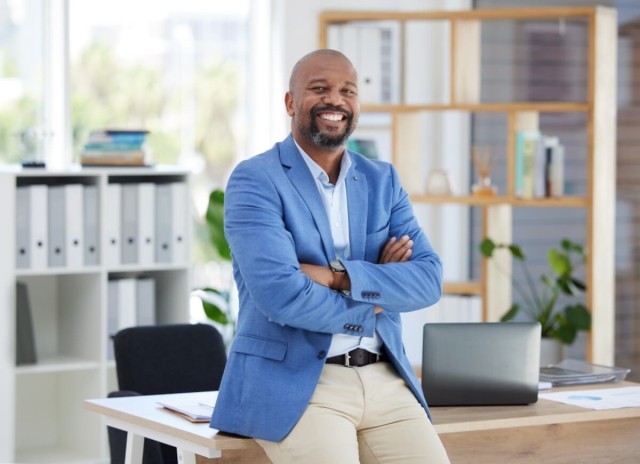 Landlord smiling in his office